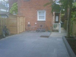 natural stone landscaping work completed in or near little italy toronto - shed assemply and placement as well as staining work also shown